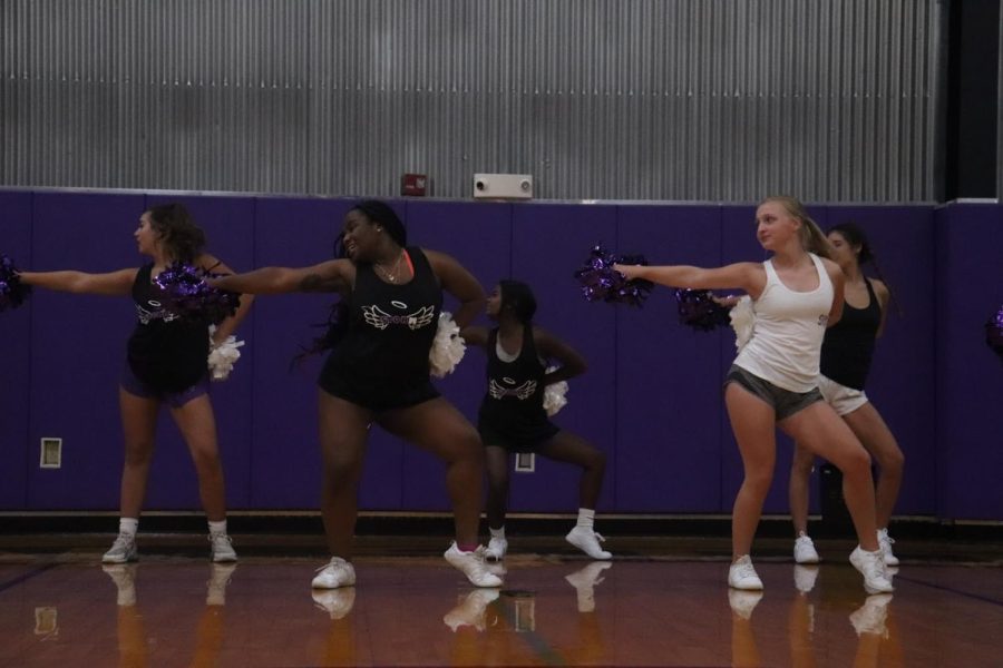 The cheer team practices their pep assembly routine