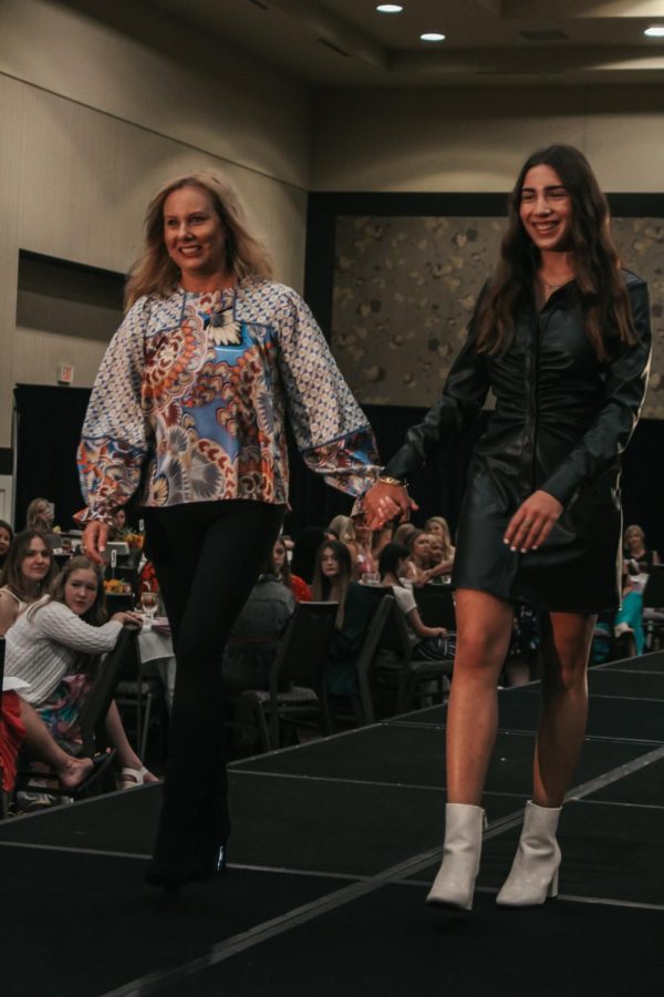 Senior Elle Simon and her aunt Amber DiCioccio strut down the runway in their outfits from Clothology 135.