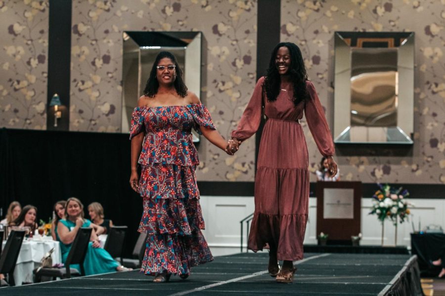 With a smile on her face senior Eden Davis walks the runway with her mom Jessica Davis.