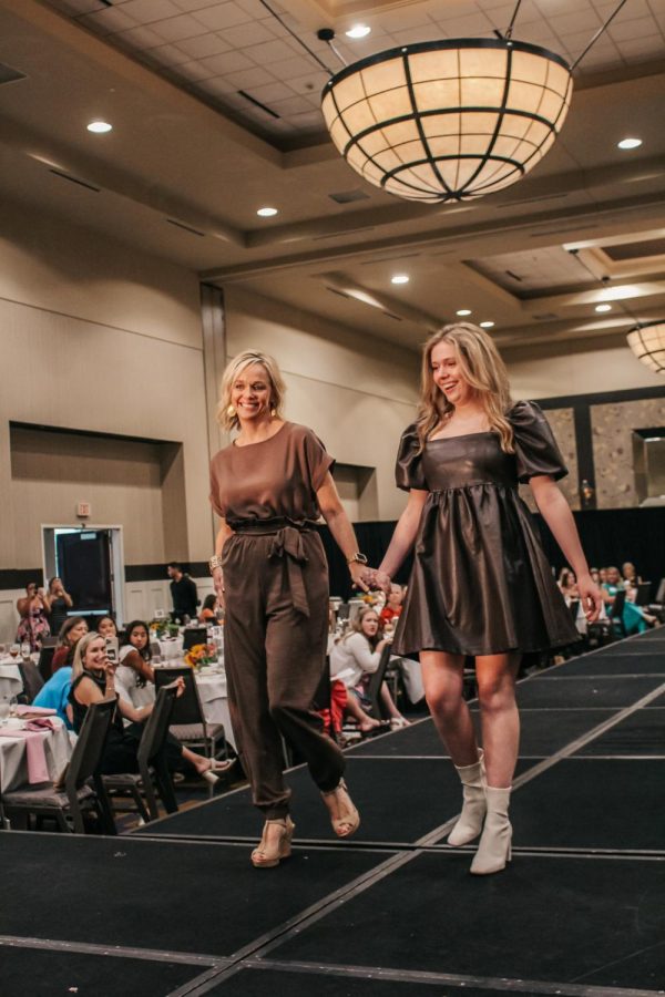 Senior Chloe Welch walks hand in hand with her mom Jennifer Welch.