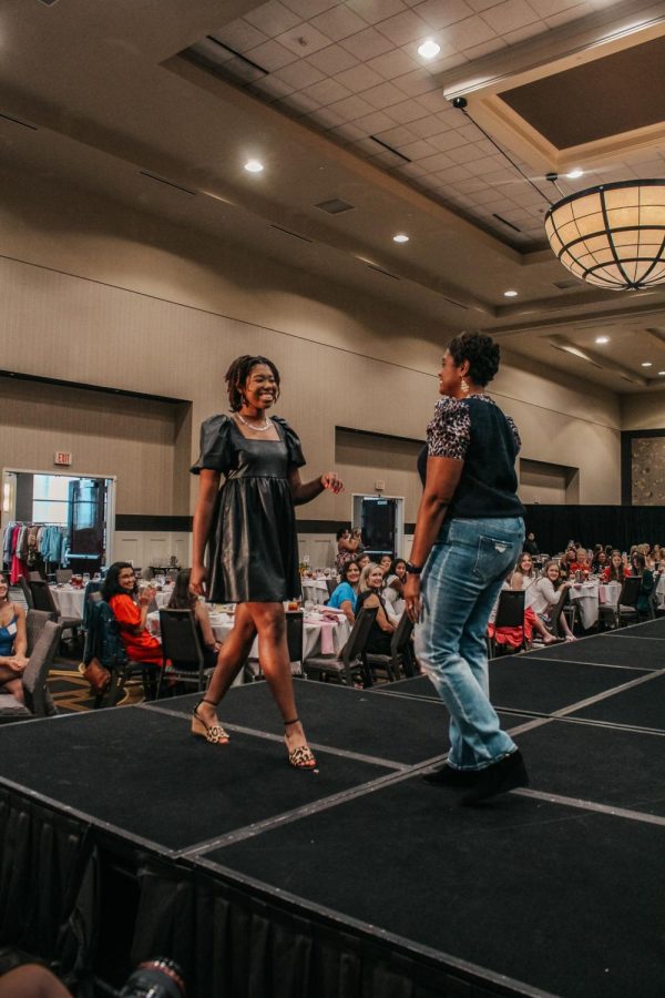 Senior Kori Franklin and her mom Micole Franklin walk towards each other at the end of the runway.