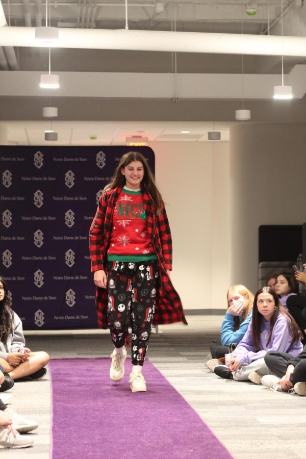 Sophomore Anna Kate Schweers walks down the runway in Christmas pajamas.