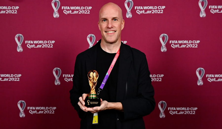 Grant Wahl stands with a World Cup replica trophy Tuesday, Nov. 29 during the FIFA Journalist on the Podium ceremony in Doha, Qatar. 