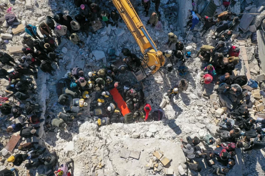 Search and rescue teams dig through the rubble in hopes of finding survivors in Salqin, Syria.