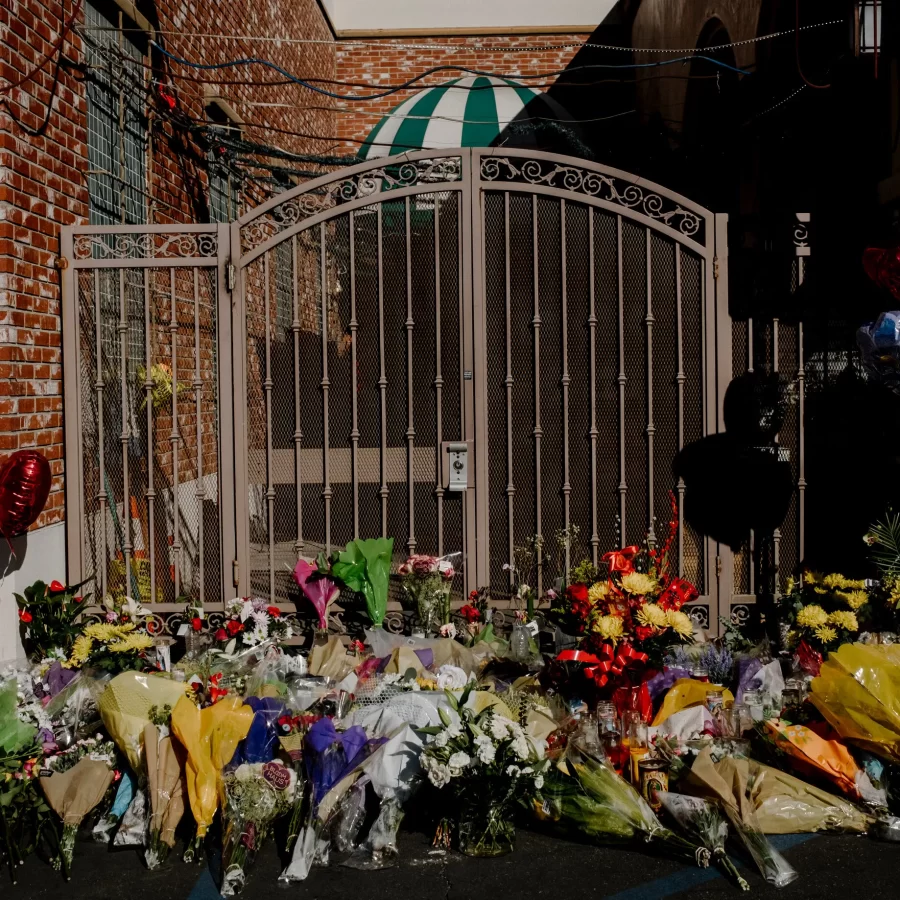 A memorial of flowers lays outside of the gate of the dance studio in Monterey Park following the shooting on Jan. 22