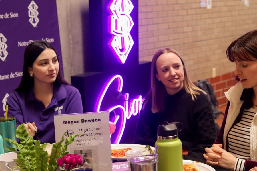 Junior Maddie Shipley and high school director at Leawood Presbyterian Megan Dawson listen intently to middle school director Presley Wilson.