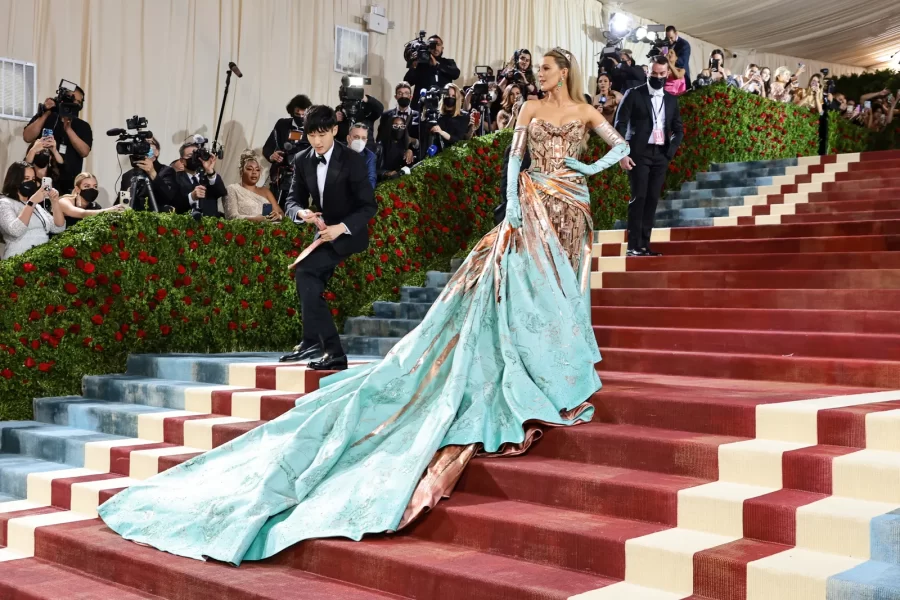 Actress Blake Livelys custom Versace gown, resembling classic New York architecture, cascades down the steps of the Met at the 2022 Met Gala. 