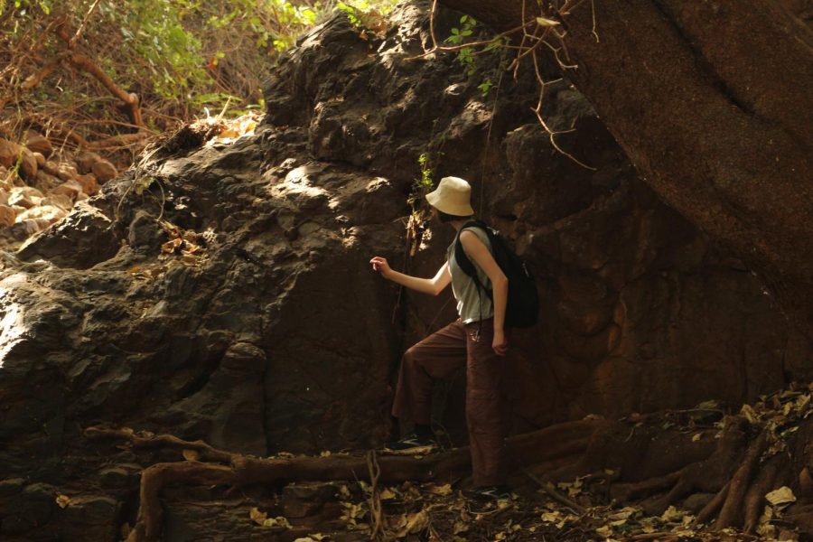 Junior Kate Wren starts to climb the rocks leading to a precipice.