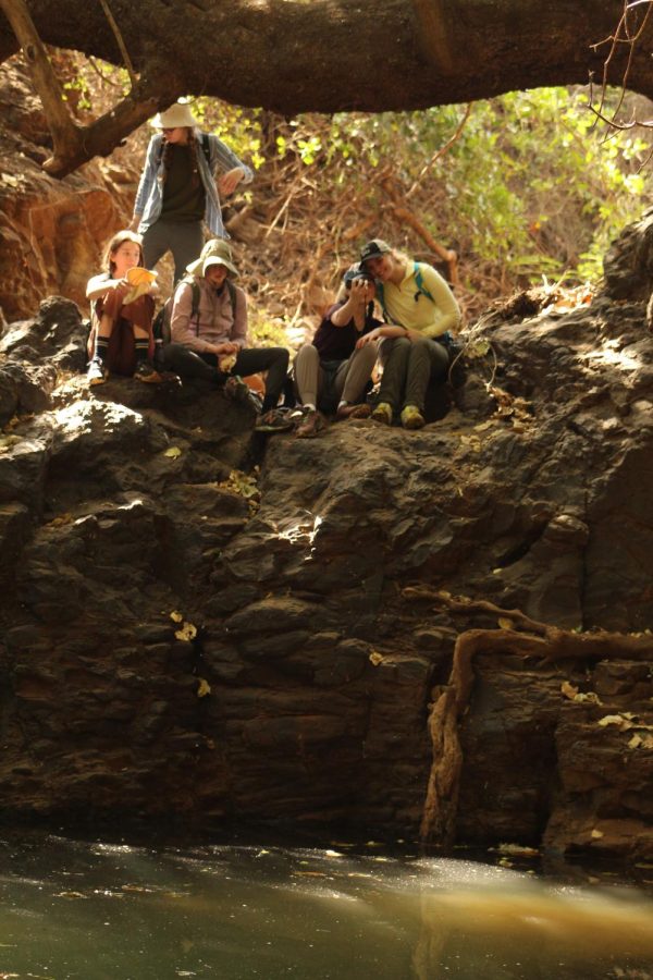 While sitting on the rocks Juniors Suzanne Sade and Lucy Wittek lean in for a selfie while Sophmore Ella Satterwhite and Junior Kate Wren admire the scenery.