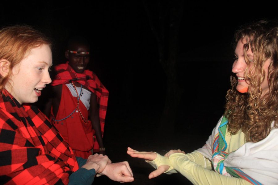 Joseph teaches junior Lucy Wittek and sophmore Ella Satterwhite how to play a traditional Maasai game.