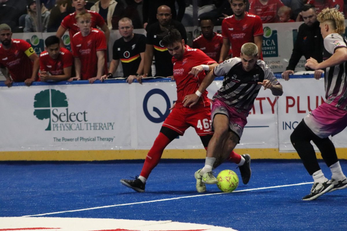 In the Comets vs Strykers game defender Chase Peterson attempts to steal the ball from a Stryker player.