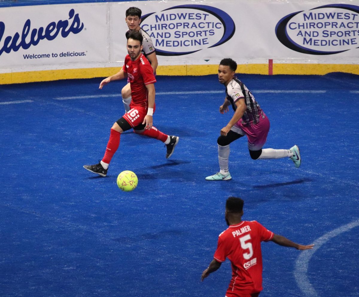 Comet's forward Ramone Palmer passes the ball to midfielder Henry Ramirez in the third quarter.