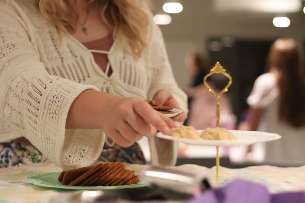 Tea Party:
At the after-school tea party, senior Kate Schneeberger reaches for a biscuit.
